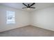 Spacious bedroom with ceiling fan and neutral carpeting at 4720 E Belleview St, Phoenix, AZ 85008