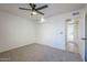 Bright bedroom with ceiling fan, large closet, and access to a hallway at 4720 E Belleview St, Phoenix, AZ 85008