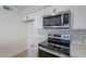 Bright kitchen with white cabinets, stainless steel stove and microwave at 4720 E Belleview St, Phoenix, AZ 85008