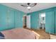 Bedroom with light pink bedding and teal walls at 508 E Griswold Rd, Phoenix, AZ 85020