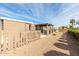 Large backyard with a wooden fence and covered patio area at 5241 E Lindstrom Ln, Mesa, AZ 85215