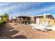 Spacious backyard with patio cover, grill, and gravel landscaping at 5241 E Lindstrom Ln, Mesa, AZ 85215