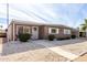 Tan single-story home with carport and palm tree in front at 5241 E Lindstrom Ln, Mesa, AZ 85215