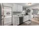 Updated kitchen with white cabinets and a view to dining area at 5241 E Lindstrom Ln, Mesa, AZ 85215