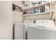 Laundry room with washer, dryer, and shelves at 5241 E Lindstrom Ln, Mesa, AZ 85215