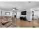 Open living room with comfortable seating and hardwood floors at 5241 E Lindstrom Ln, Mesa, AZ 85215