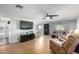Living room with hardwood floors and a large TV at 5241 E Lindstrom Ln, Mesa, AZ 85215