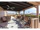 Relaxing covered patio with comfortable seating and desert views at 5241 E Lindstrom Ln, Mesa, AZ 85215