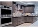 Updated kitchen with double ovens and gas cooktop at 7347 E Milton Dr, Scottsdale, AZ 85266