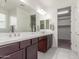 Elegant bathroom with double vanity and walk-in closet access at 7438 W Jasmine Trl, Peoria, AZ 85383