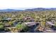 Aerial view showcasing a single-story home, pool, and surrounding desert landscape at 7760 E Carefree Dr, Carefree, AZ 85377