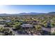 Aerial view of single-story home with pool, desert landscaping, and mountain views at 7760 E Carefree Dr, Carefree, AZ 85377