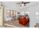 Bright home office features wood desk, window, and tile floors at 7760 E Carefree Dr, Carefree, AZ 85377