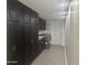 Laundry room with dark cabinets and tile flooring at 7760 E Carefree Dr, Carefree, AZ 85377