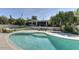 Stunning turquoise pool with a view of the home and landscaping at 7760 E Carefree Dr, Carefree, AZ 85377