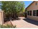 Landscaped backyard with a brick patio and a large shade tree at 8014 E Plata Ave, Mesa, AZ 85212