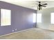 A spacious bedroom with carpet, neutral-toned walls, and multiple windows provides ample natural light at 8014 E Plata Ave, Mesa, AZ 85212
