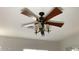 A unique ceiling fan with lights and wooden blades is prominently featured in the room at 8014 E Plata Ave, Mesa, AZ 85212