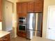 Modern stainless steel refrigerator and built-in oven enhance the kitchen's functionality and appeal at 8014 E Plata Ave, Mesa, AZ 85212