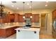Bright kitchen features updated cabinetry, sleek appliances, and a practical center island with pendant lighting at 8014 E Plata Ave, Mesa, AZ 85212