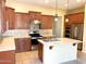Open kitchen boasts ample cabinetry, stainless steel appliances, and a center island with a sink at 8014 E Plata Ave, Mesa, AZ 85212