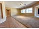 Spacious living room with carpet, neutral toned walls, and several windows for natural light at 8014 E Plata Ave, Mesa, AZ 85212