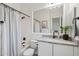 Simple bathroom with a tub, toilet and modern vanity at 8040 E Laurel St, Mesa, AZ 85207