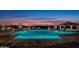 Large lighted community pool at sunset with mountain views at 8040 E Laurel St, Mesa, AZ 85207