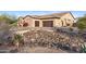 Home exterior showcasing a large driveway and rock landscaping at 8040 E Laurel St, Mesa, AZ 85207
