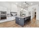 Sleek kitchen with expansive island, stainless steel appliances, and white cabinets at 8040 E Laurel St, Mesa, AZ 85207