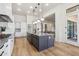 Island kitchen features sleek cabinetry and breakfast bar at 8040 E Laurel St, Mesa, AZ 85207