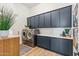 Modern laundry room with dark cabinetry and ample storage at 8040 E Laurel St, Mesa, AZ 85207