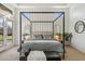Main bedroom features a canopy bed and access to the backyard at 8040 E Laurel St, Mesa, AZ 85207