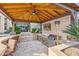 Covered outdoor kitchen with grill and TV, perfect for entertaining at 8040 E Laurel St, Mesa, AZ 85207