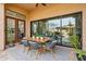 Covered patio with wooden table and chairs, offering an outdoor dining space at 8040 E Laurel St, Mesa, AZ 85207