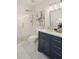 Modern bathroom with a walk-in shower, white subway tile, and dark vanity at 8638 E Whitton Ave, Scottsdale, AZ 85251