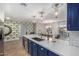 Modern kitchen with blue cabinets, white countertops, and breakfast bar at 8638 E Whitton Ave, Scottsdale, AZ 85251