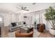 Cozy living room with gray sofa, wood flooring, and large windows at 8638 E Whitton Ave, Scottsdale, AZ 85251