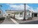 Mobile home with covered carport and desert landscaping at 880 Motherlode Dr # 1099, Apache Junction, AZ 85119