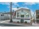 Mobile home with covered carport and desert landscaping at 880 Motherlode Dr # 1099, Apache Junction, AZ 85119