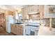 Clean and efficient kitchen with a gas range and white appliances at 880 Motherlode Dr # 1099, Apache Junction, AZ 85119