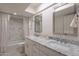 Bathroom with double vanity, marble countertop and a bathtub shower combo at 9254 N 82Nd St, Scottsdale, AZ 85258
