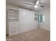 Spacious bedroom with built-in wall unit and a ceiling fan at 9254 N 82Nd St, Scottsdale, AZ 85258