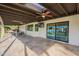 Covered patio with dining area, ceiling fan, and sliding glass doors at 9254 N 82Nd St, Scottsdale, AZ 85258