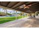 Covered patio overlooks a lush backyard with a sparkling pool at 9254 N 82Nd St, Scottsdale, AZ 85258