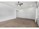 Spacious bedroom with neutral carpeting and ceiling fan at 9438 W Weeping Willow Rd, Peoria, AZ 85383