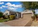 Single-story home with landscaped front yard, driveway, and two-car garage at 9438 W Weeping Willow Rd, Peoria, AZ 85383