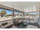 This enclosed patio features wicker furniture, a ceiling, and views of the neighborhood at 10850 W Venturi Dr, Sun City, AZ 85351