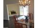 Dining area with a glass table, chandelier, and fireplace at 11133 W Granada Dr, Sun City, AZ 85373