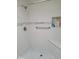 Walk-in shower with grab bar and tiled walls at 11133 W Granada Dr, Sun City, AZ 85373